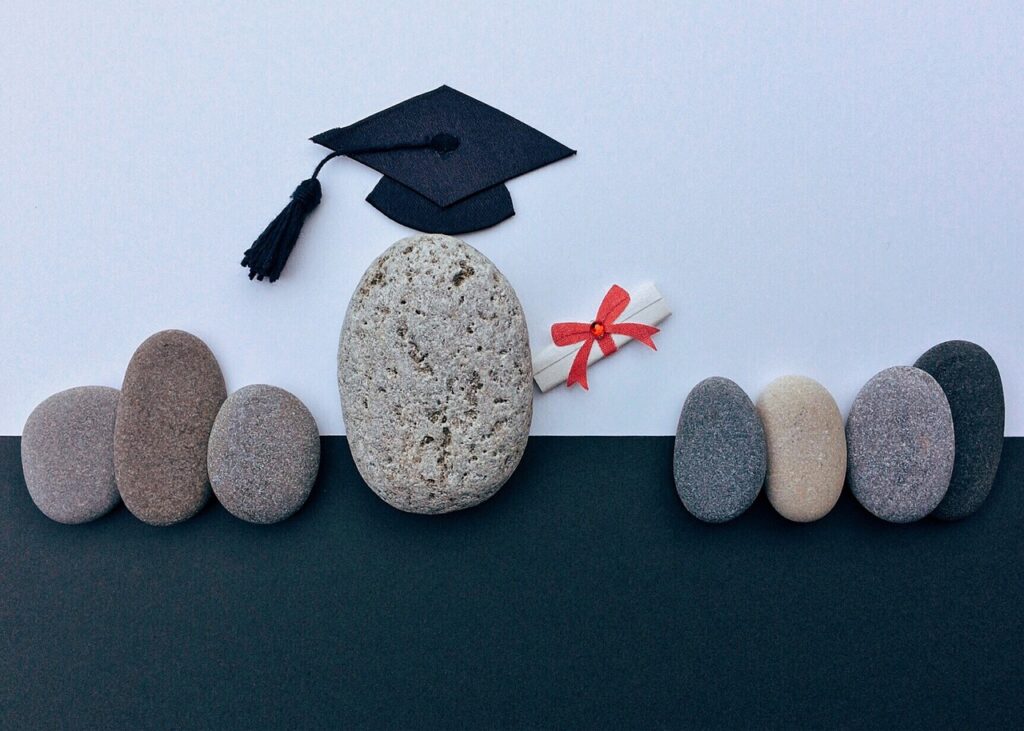 a group of rocks, one has the qualification of a graduation cap and degree