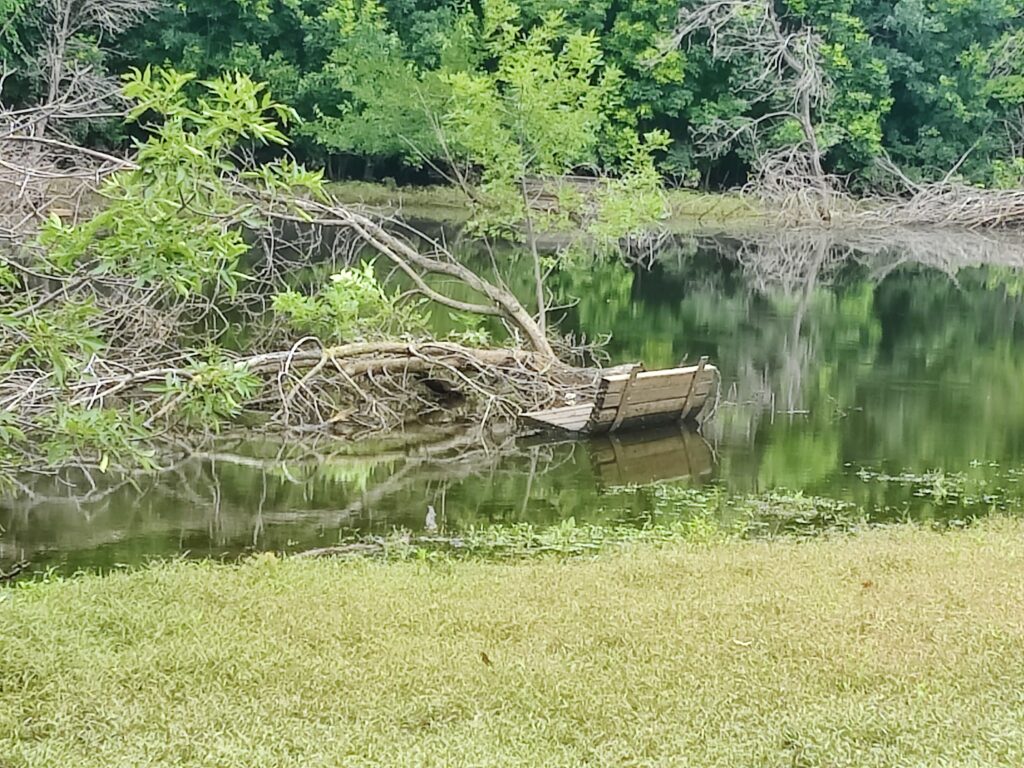 park bench in water after a rain; concept of being surrounded by trouble