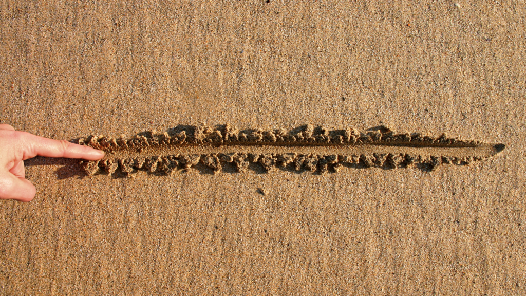 finger drawing line in the sand; boundaries