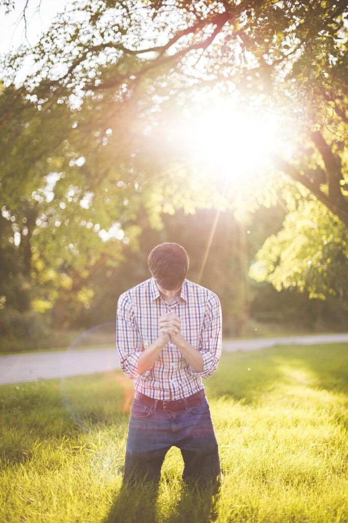 man on his knees praying; one job is service to God